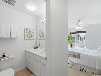 a bathroom with a sink a toilet and mirror