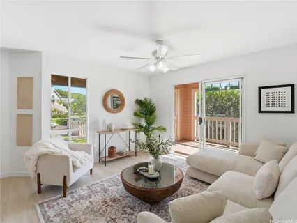 a living room with furniture a fireplace and a large window
