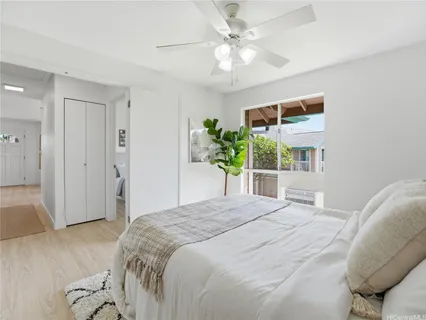 a bedroom with a bed and a chandelier