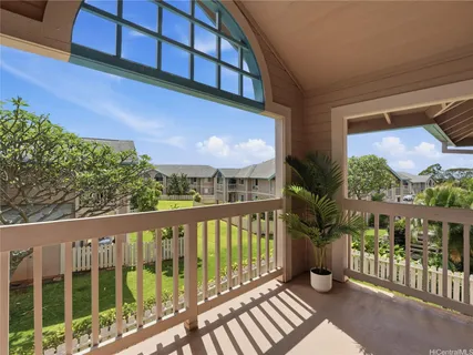 a view of a balcony with potted plants