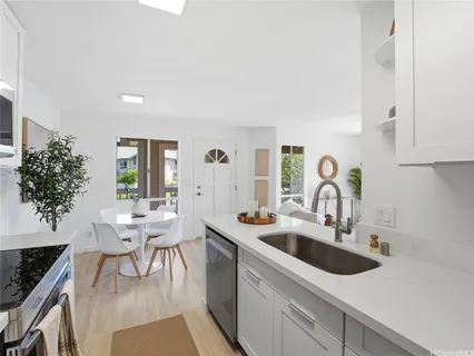 a kitchen with a sink and a stove top oven