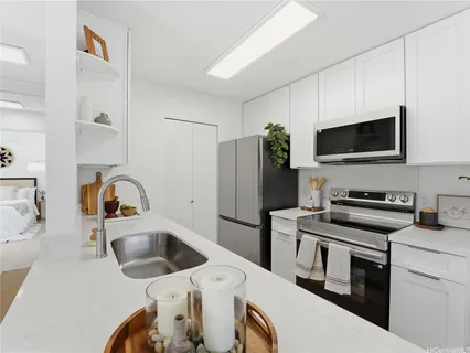 a kitchen with a sink a stove a refrigerator and a microwave