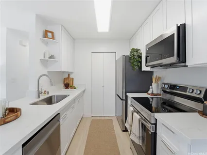 a kitchen that has a sink and a stove in it