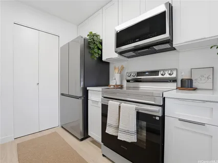 a kitchen with stainless steel appliances a stove a microwave and a refrigerator
