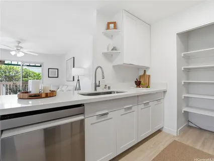 a kitchen with white cabinets and a sink