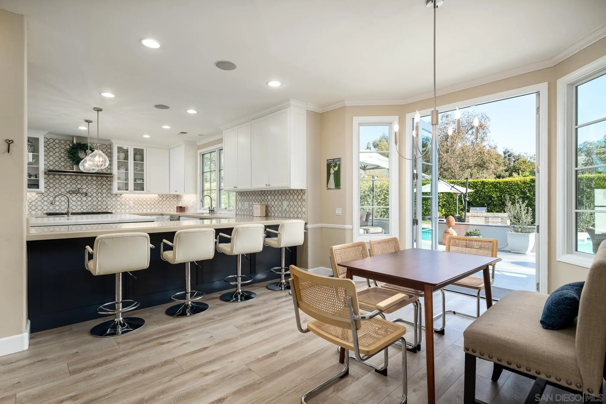 17323 Circa Del Sur Rancho Santa Fe, CA 92067 - Photo 13 of 41 a kitchen with a dining table chairs and white cabinets