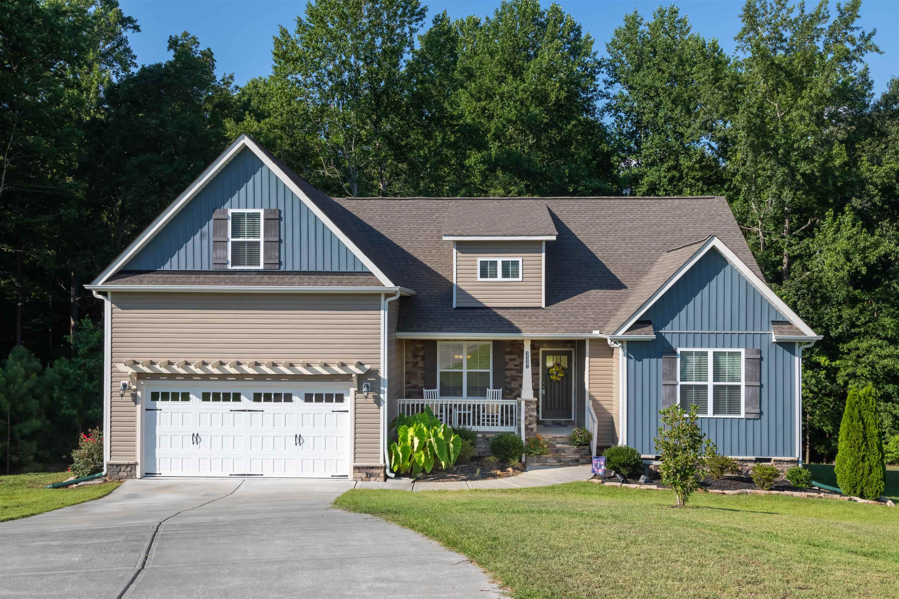 a front view of a house with garden