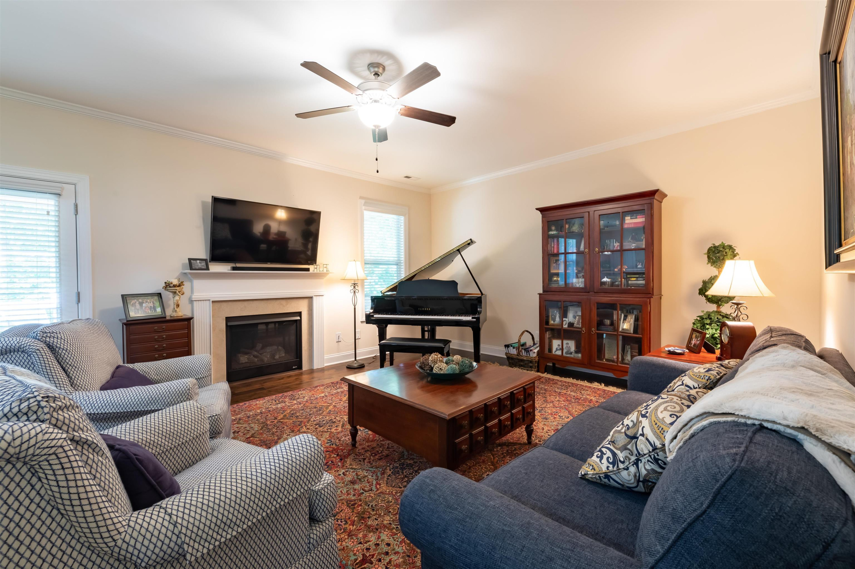 3537 Lavender Lane Wake Forest, NC 27587 - Photo 15 of 60 a living room with furniture a fireplace and a flat screen tv
