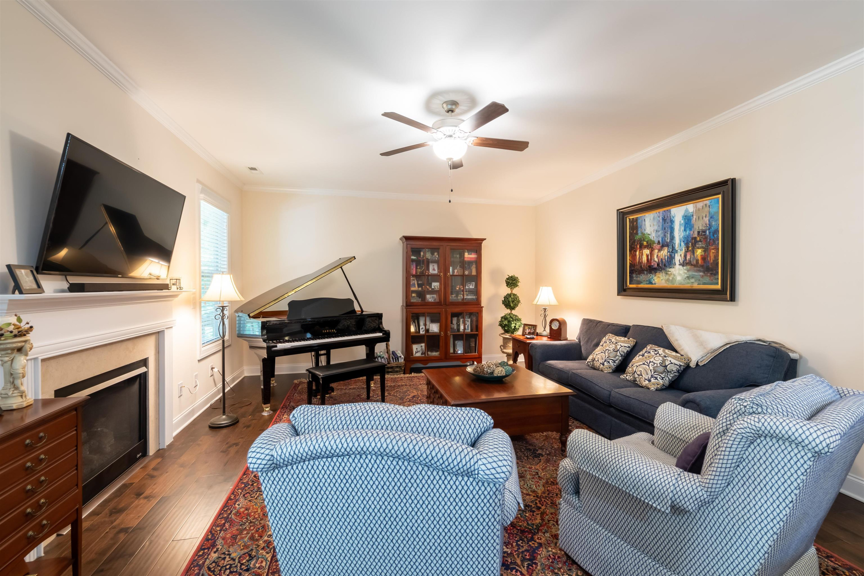 3537 Lavender Lane Wake Forest, NC 27587 - Photo 17 of 60 a living room with furniture a flat screen tv and a fireplace