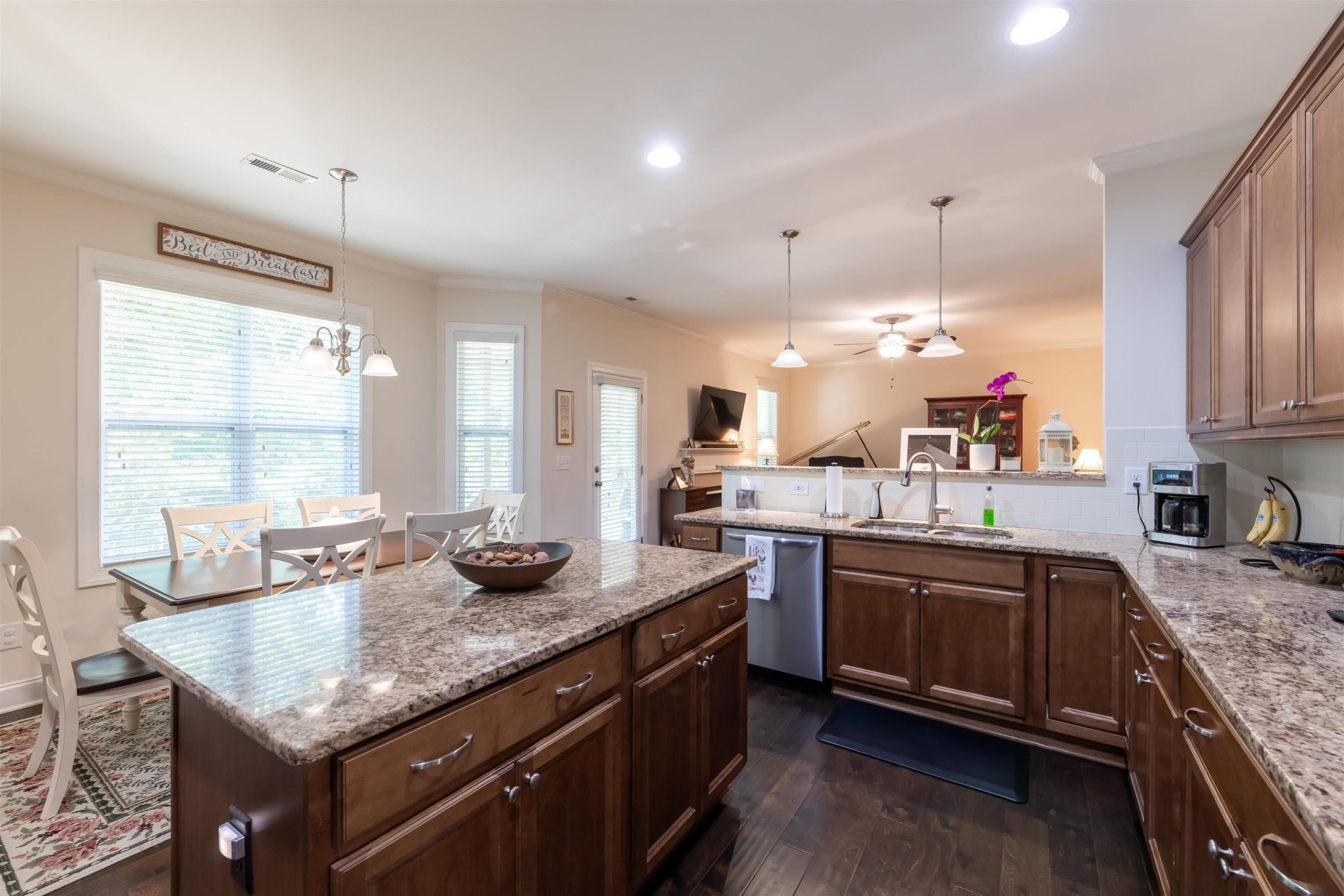 3537 Lavender Lane Wake Forest, NC 27587 - Photo 18 of 60 a kitchen with granite countertop kitchen island stainless steel appliances a sink stove and cabinets