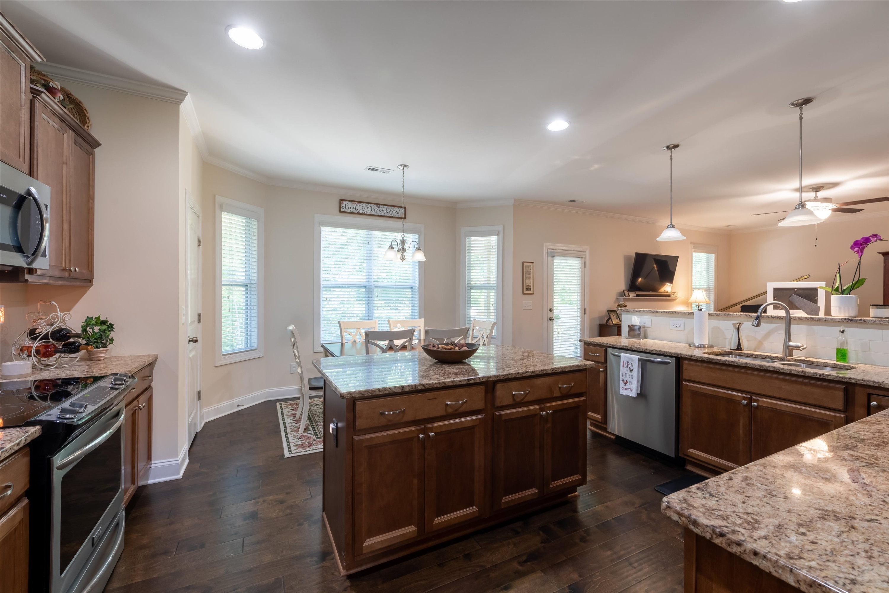 3537 Lavender Lane Wake Forest, NC 27587 - Photo 19 of 60 a kitchen with granite countertop a sink stove and cabinets
