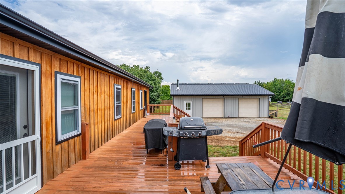1451 Dixie Hill Road Dillwyn, VA 23936 - Photo 24 of 51 Expansive wood-finish deck with railing and stairs