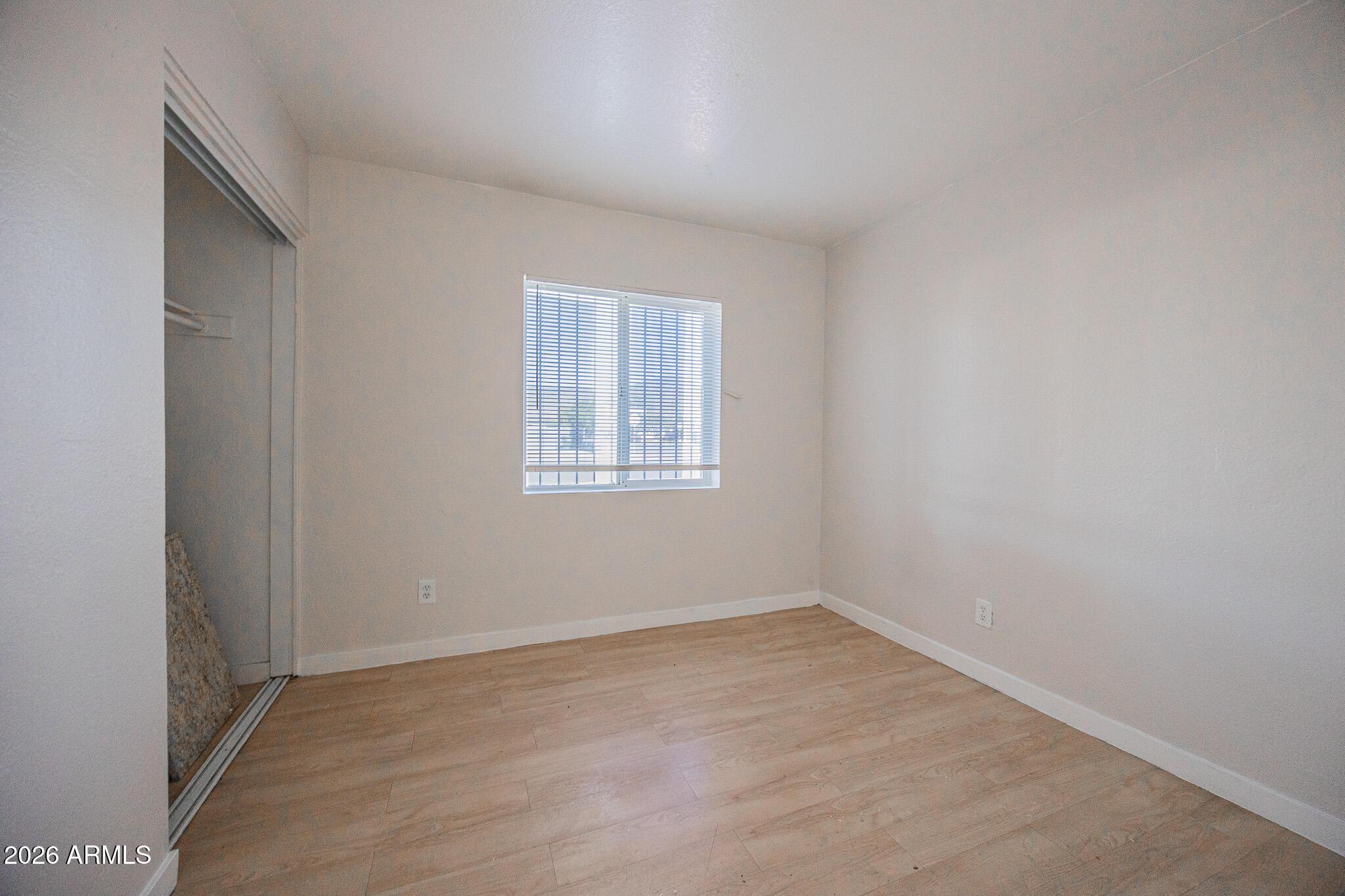 1703 West Mountain View Road, Unit 4 Phoenix, AZ 85021 - Photo 12 of 13 an empty room with a window