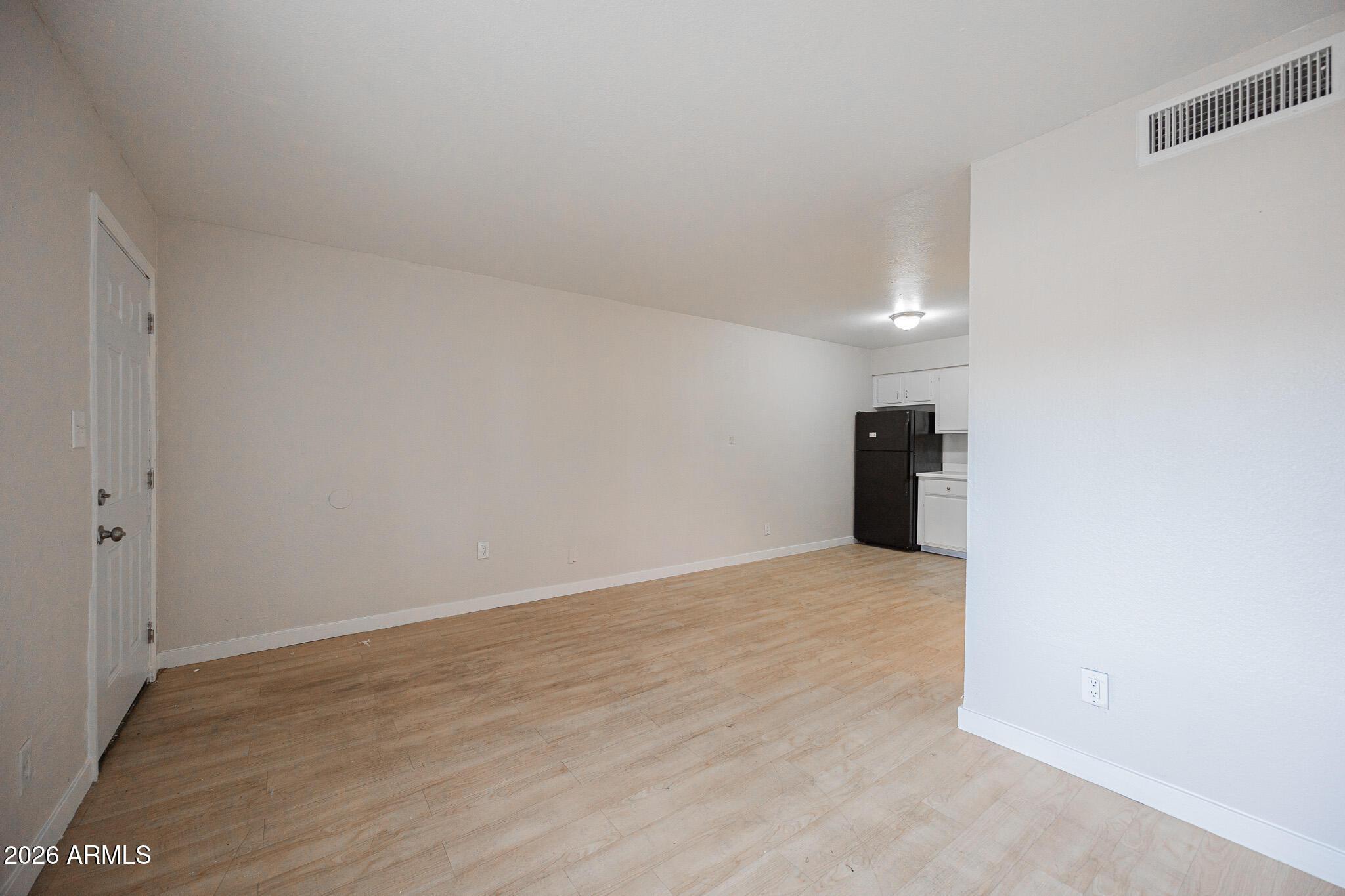1703 West Mountain View Road, Unit 4 Phoenix, AZ 85021 - Photo 5 of 13 a view of an empty room with closet and a window
