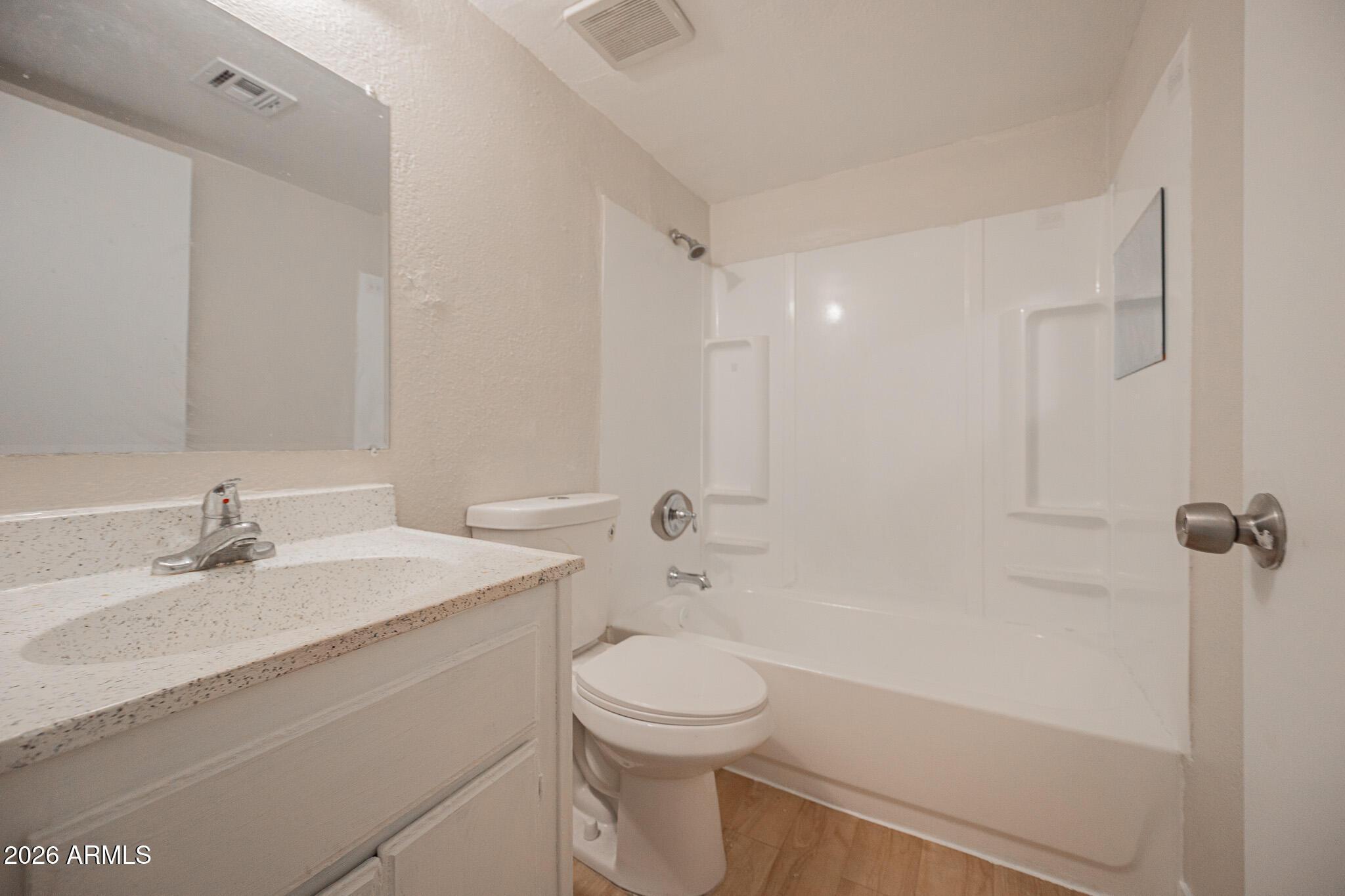 1703 West Mountain View Road, Unit 4 Phoenix, AZ 85021 - Photo 9 of 13 a bathroom with a sink a toilet and shower