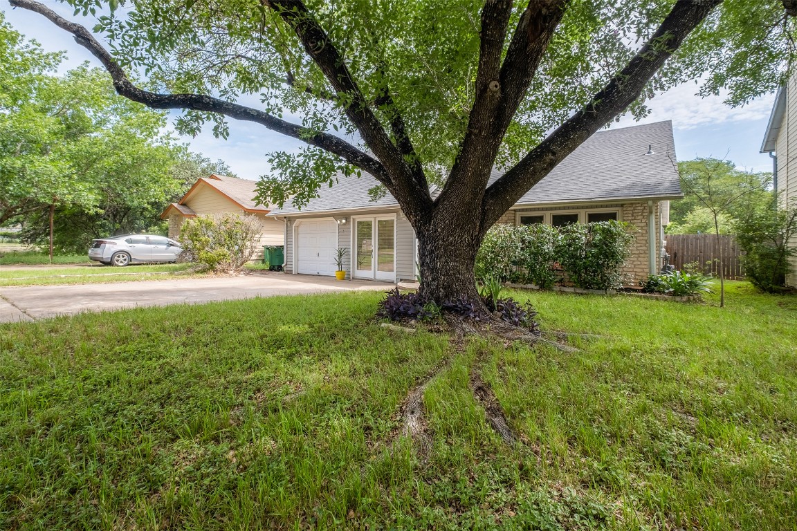 View of front of home with concrete driveway, an attached garage, and roof with shingles