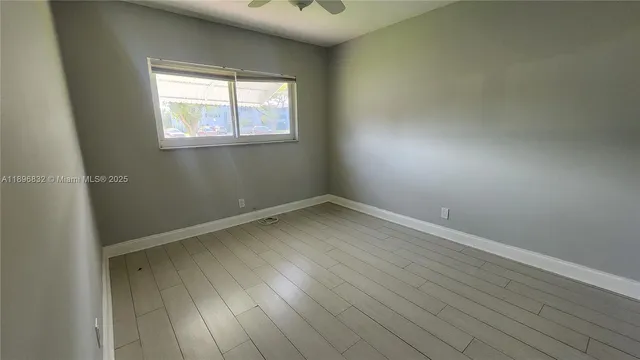 an empty room with wooden floor