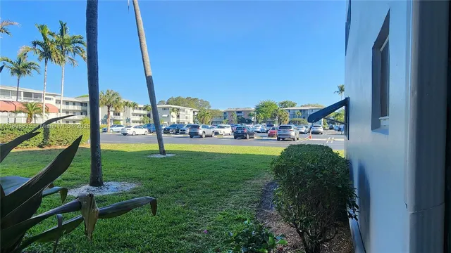 a patio with table and chairs under an umbrella