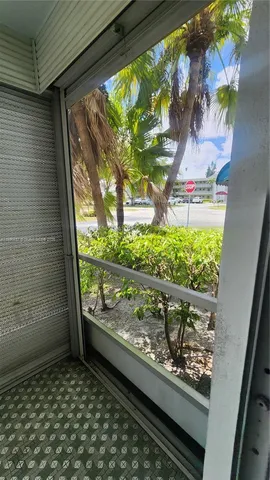 a view of empty room with window and chandelier fan