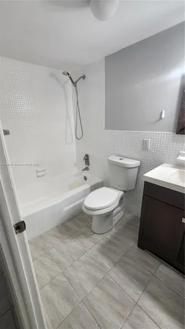 a view of a hallway with a bathroom