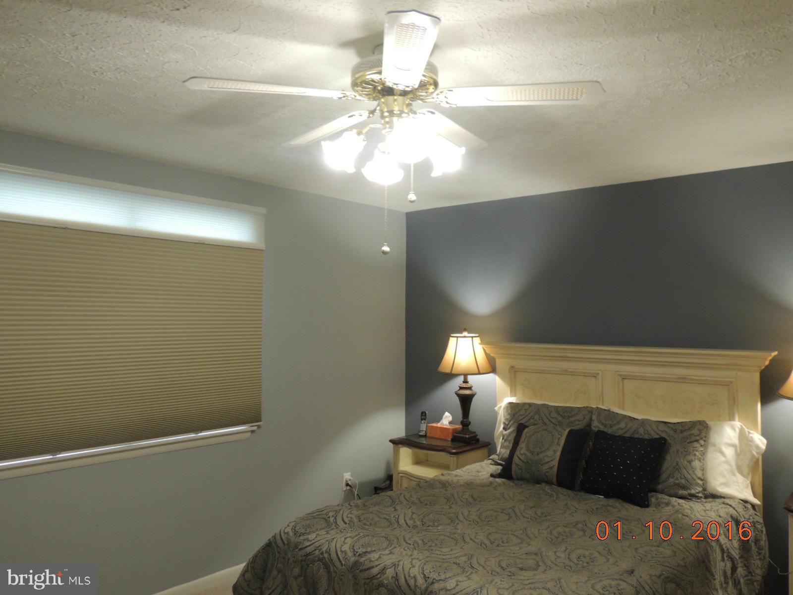 1130 Sturbridge Road Fallston, MD 21047 - Photo 16 of 29 a bedroom with a bed and a chandelier