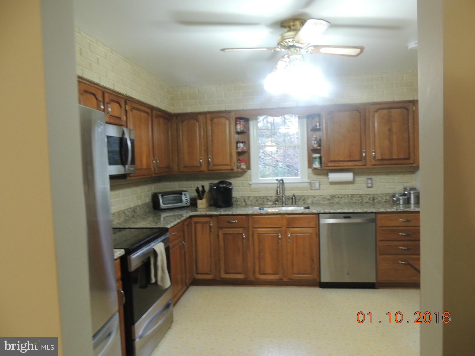 1130 Sturbridge Road Fallston, MD 21047 - Photo 9 of 29 a kitchen with granite countertop a sink cabinets stainless steel appliances and a window
