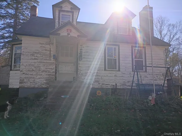 a view of a brick house with a small yard