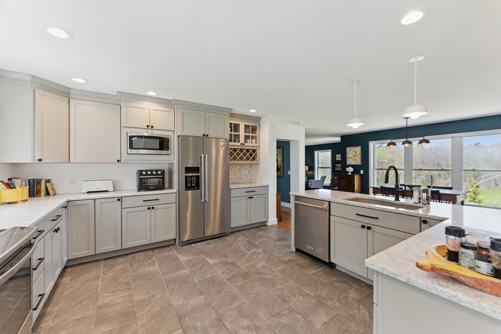 96 Cold Hill Granby, MA 01033 - Photo 11 of 42 a kitchen with white cabinets and stainless steel appliances