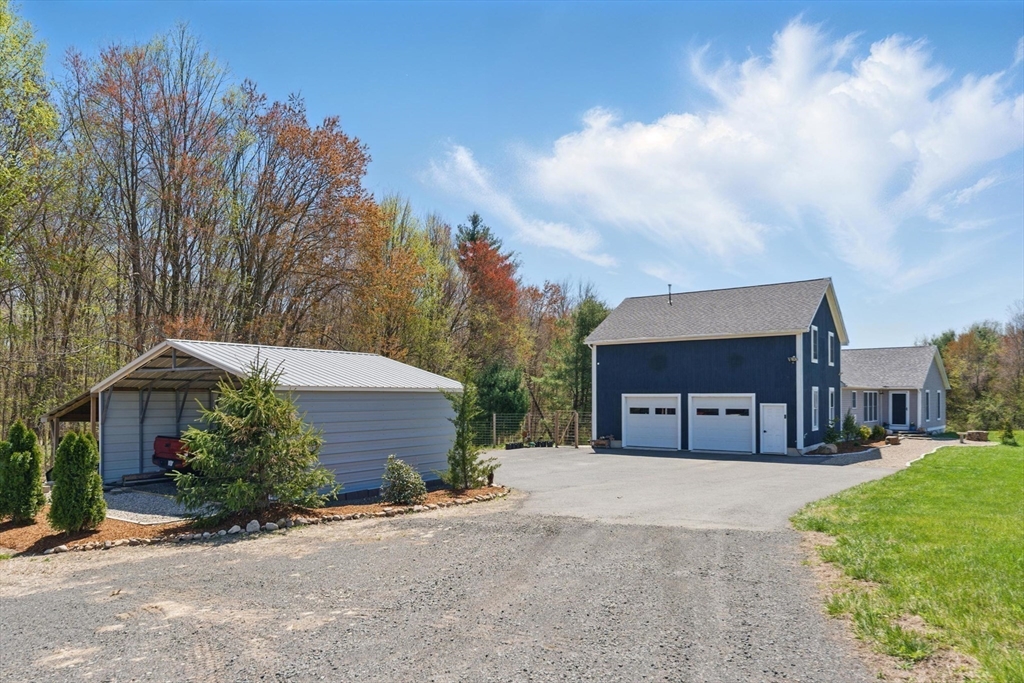 96 Cold Hill Granby, MA 01033 - Photo 41 of 42 a front view of a house with a yard and garage