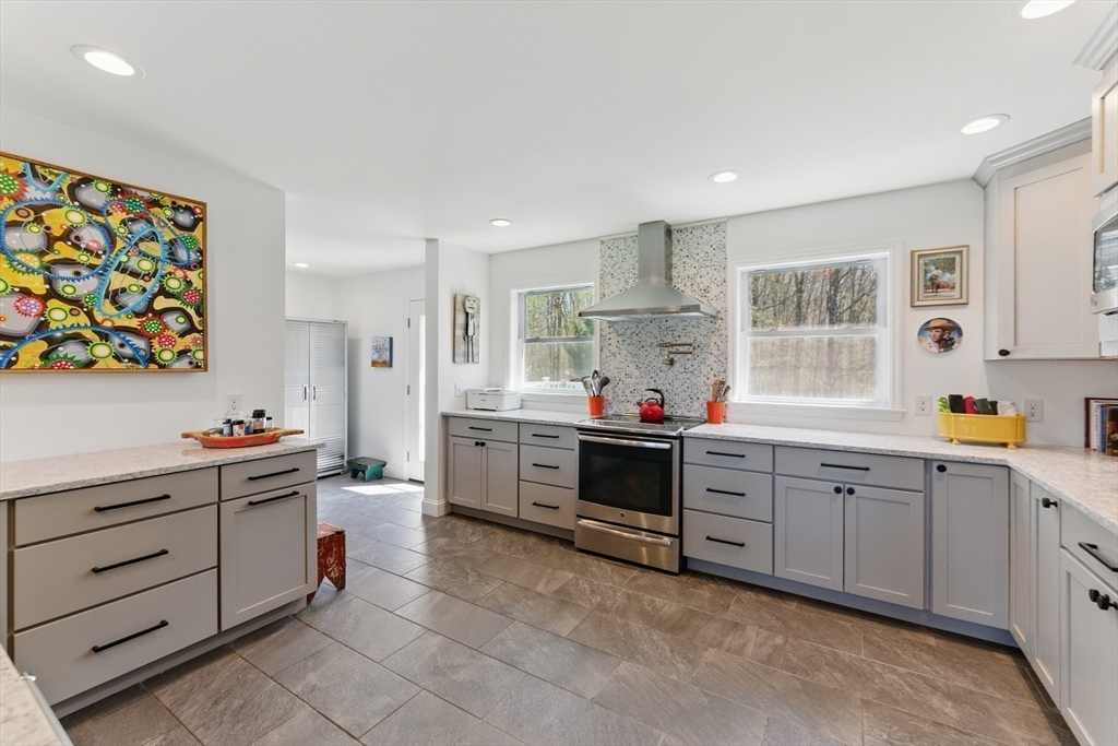 96 Cold Hill Granby, MA 01033 - Photo 9 of 42 a kitchen that has a lot of cabinets in it and wooden floors