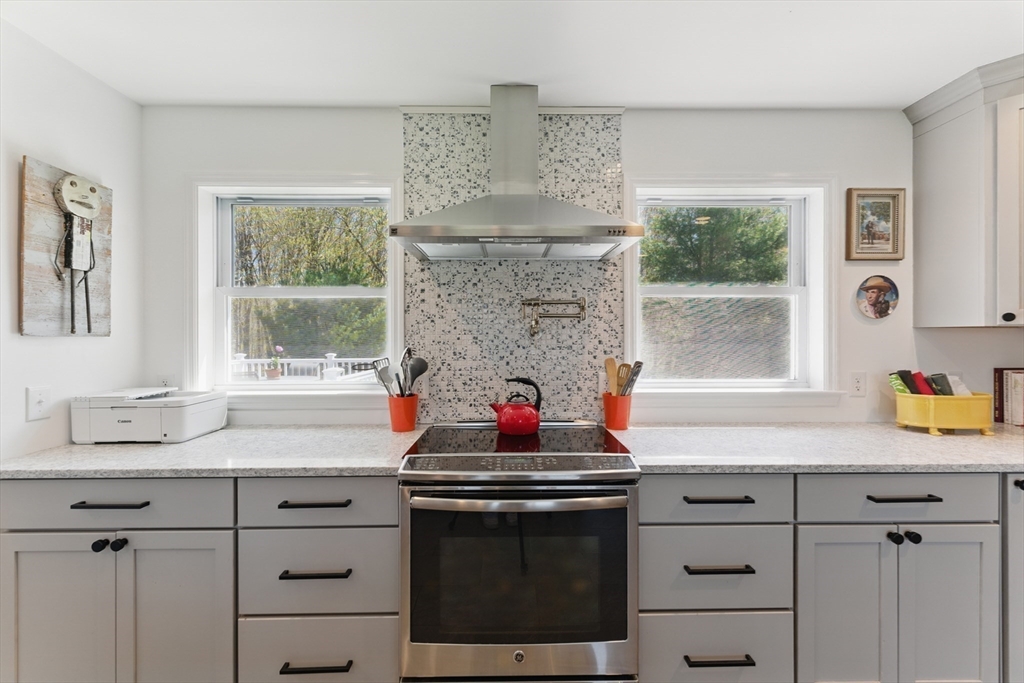 96 Cold Hill Granby, MA 01033 - Photo 10 of 42 a kitchen with stainless steel appliances granite countertop a stove a sink and a granite counter tops with a window