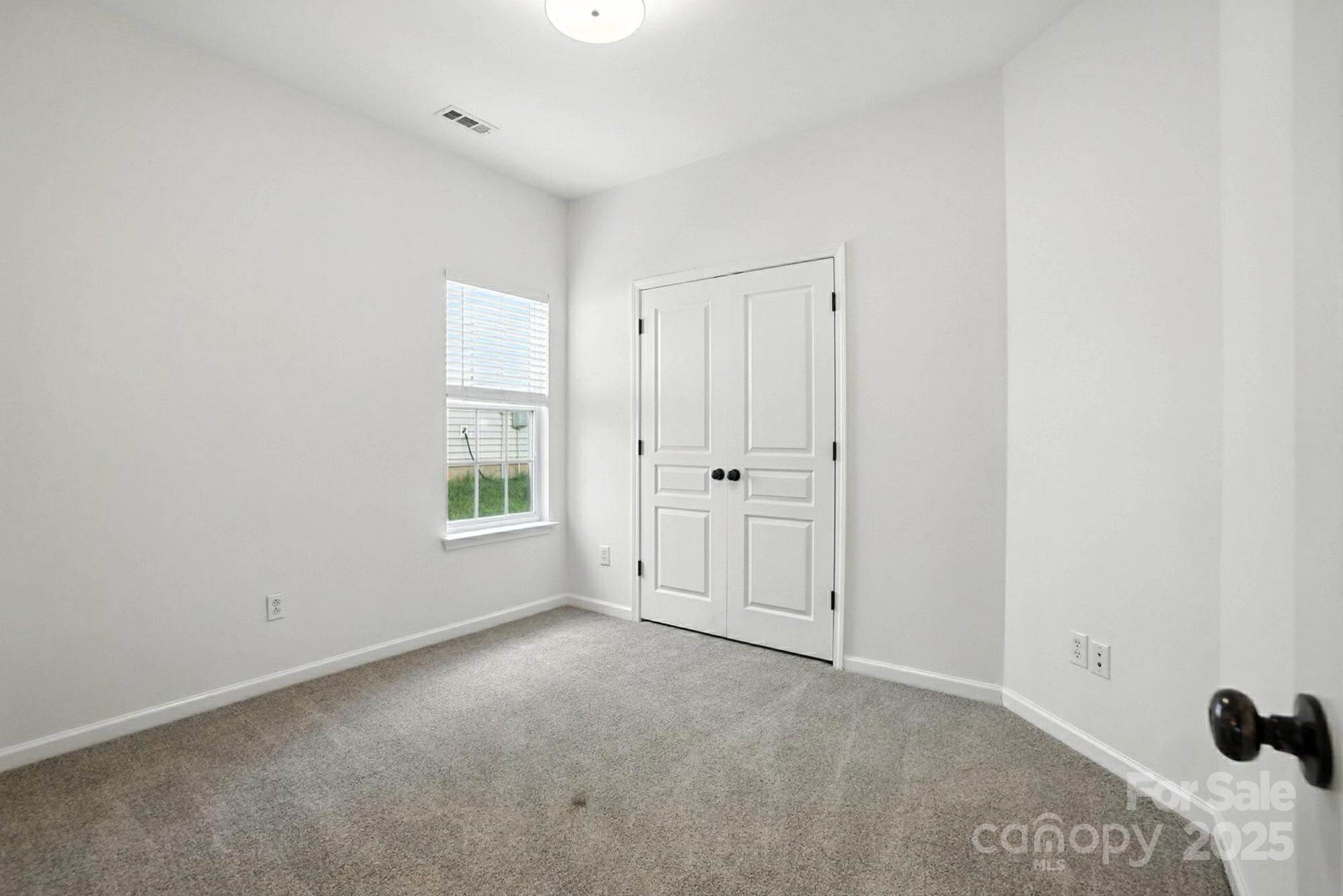 8710 Arrowhead Pl Lane Cornelius, NC 28031 - Photo 9 of 48 a view of an empty room with a window