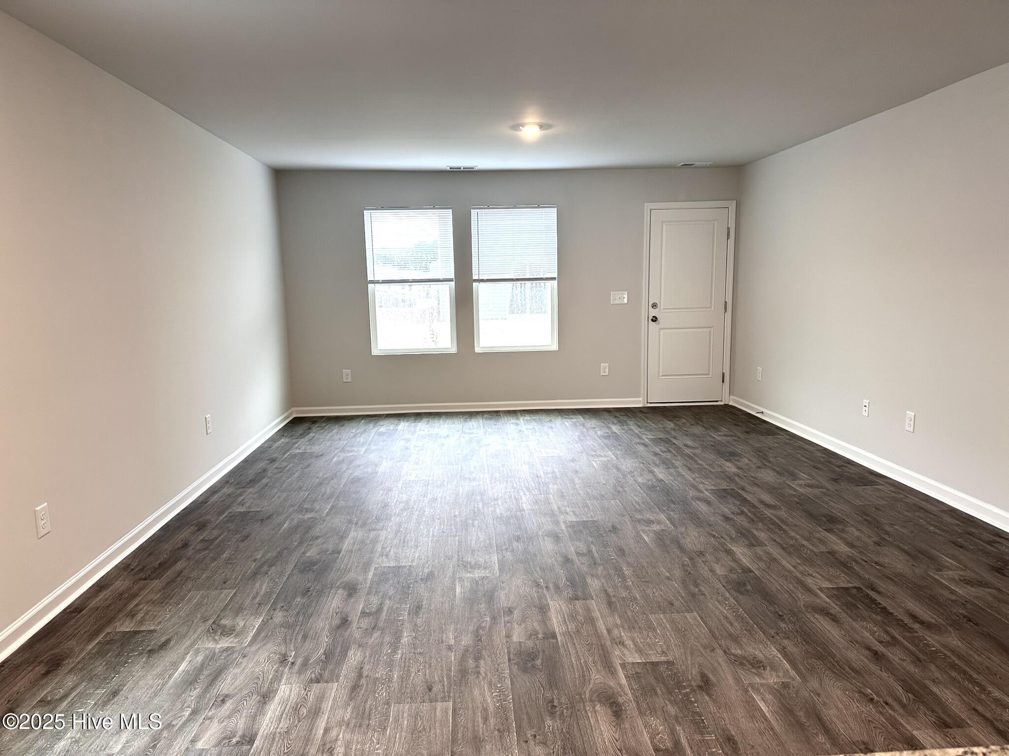 1139 Spadefish Drive Northwest, Unit LOT 146 WOODHAVEN Sunset Beach, NC 28468 - Photo 2 of 12 View of large living room from kitchen bar.