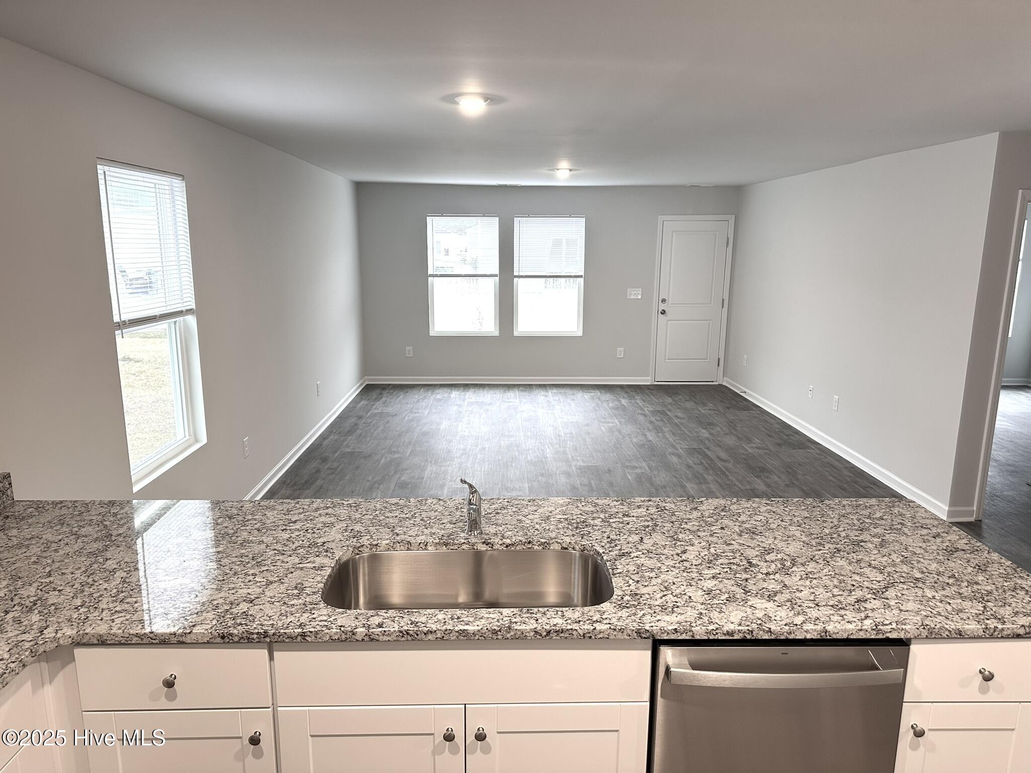 1139 Spadefish Drive Northwest, Unit LOT 146 WOODHAVEN Sunset Beach, NC 28468 - Photo 3 of 12 Kitchen bar with stainless sink and dishwasher.