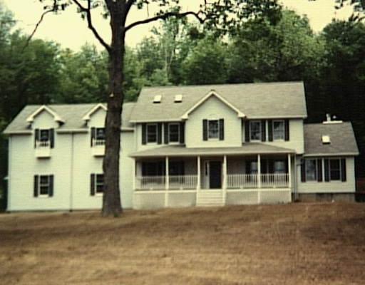 Lot Pocono Pocono Ridge Road Brookfield, CT 06804 - Photo 1 of 1 a front view of a house with a garden and tree