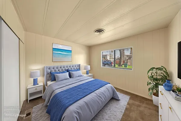 a bedroom with a bed and a painting on the wall