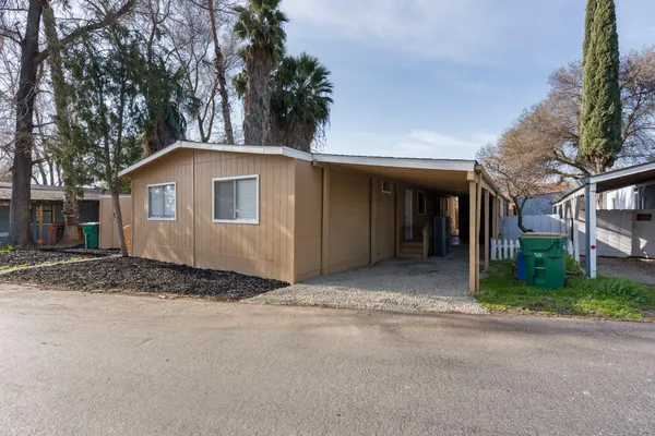 a view of a house with a yard and garage