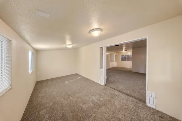 an empty room with a empty space and windows