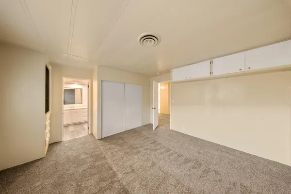 a spacious bathroom with a granite countertop sink a toilet and shower