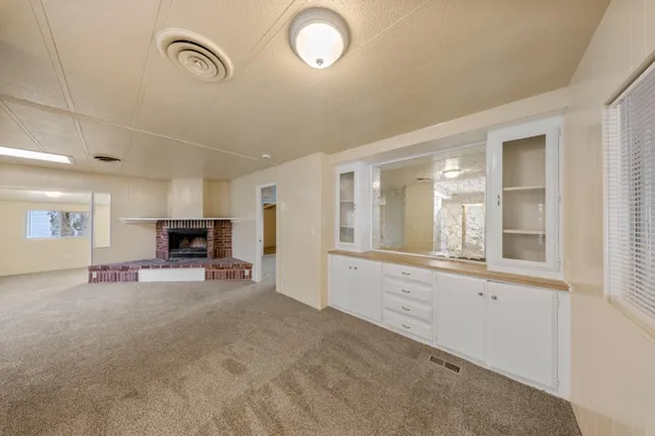 a view of a livingroom with furniture and a window