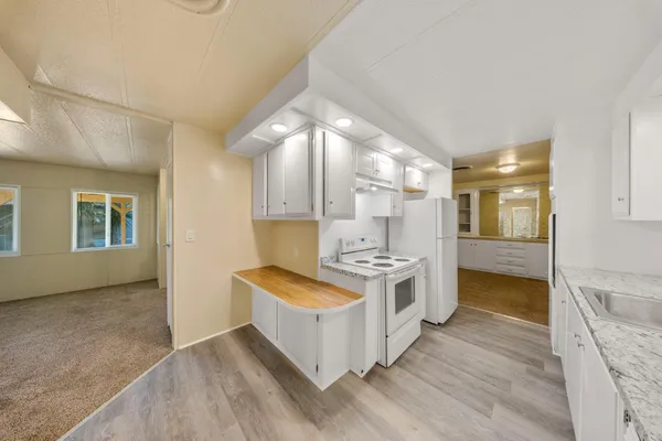a kitchen with stainless steel appliances a stove top oven and cabinets
