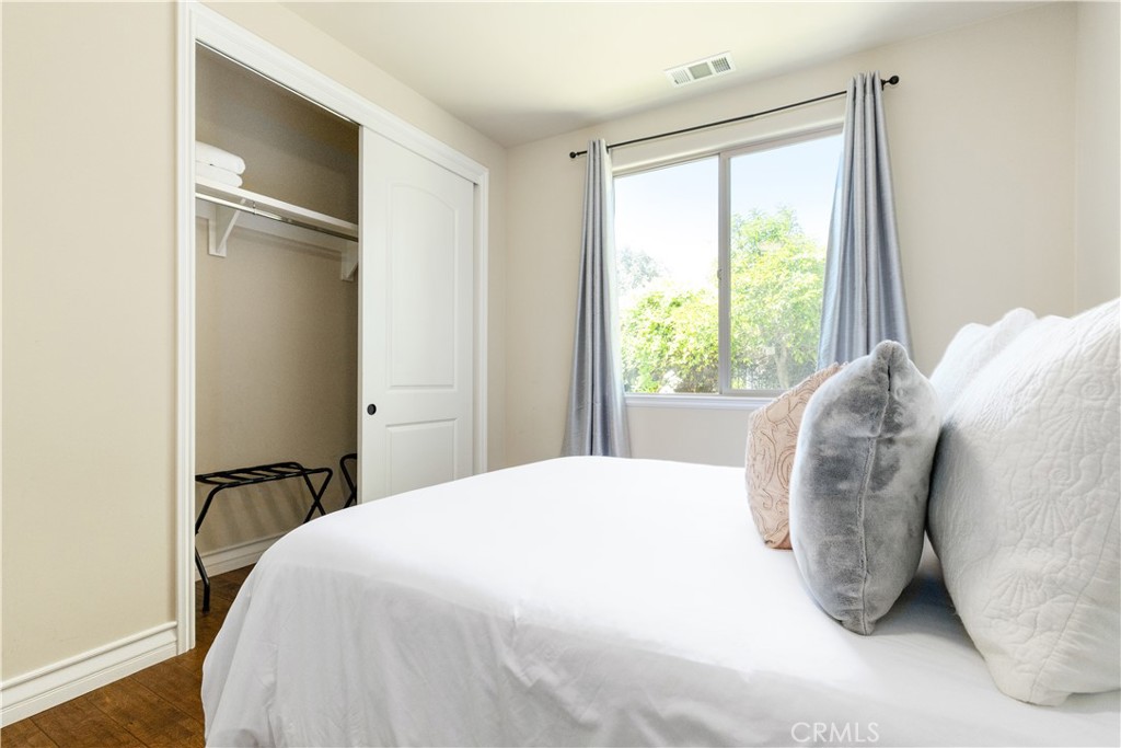 669 Red Cloud Road Paso Robles, CA 93446 - Photo 31 of 61 a bedroom with a bed and wooden floor