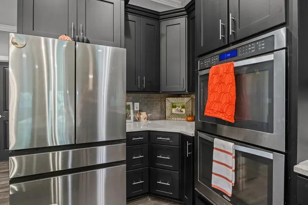 a kitchen with stainless steel appliances granite countertop a refrigerator and a sink