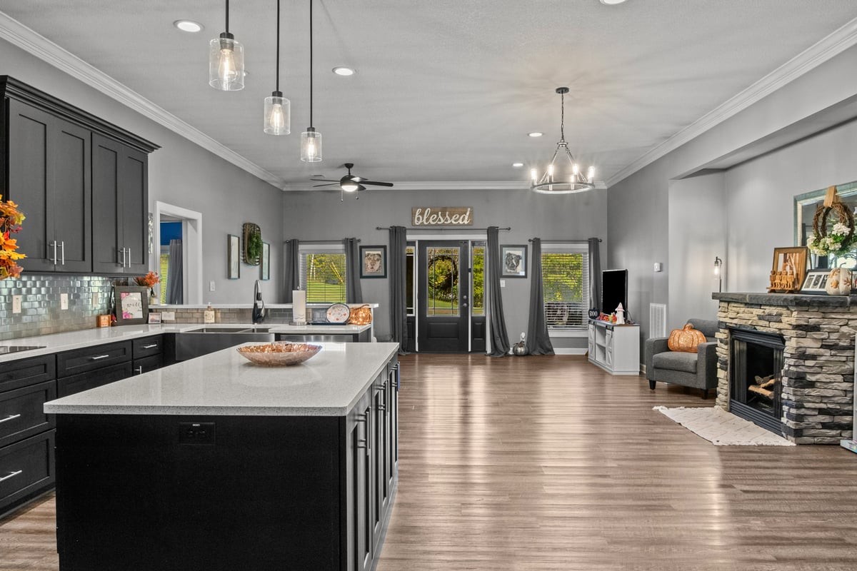 3950 Budds Creek Road Palmyra, TN 37142 - Photo 15 of 54 a view of a dining room and livingroom with furniture wooden floor a chandelier