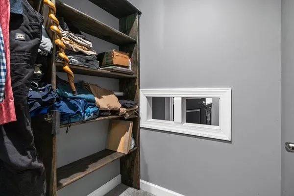 a bedroom with furniture and a window