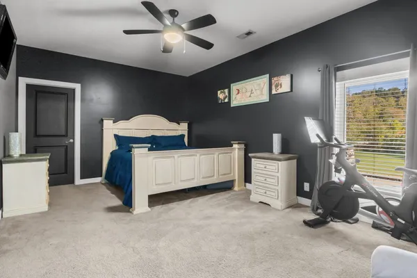 a room with gym equipment and a flat screen tv