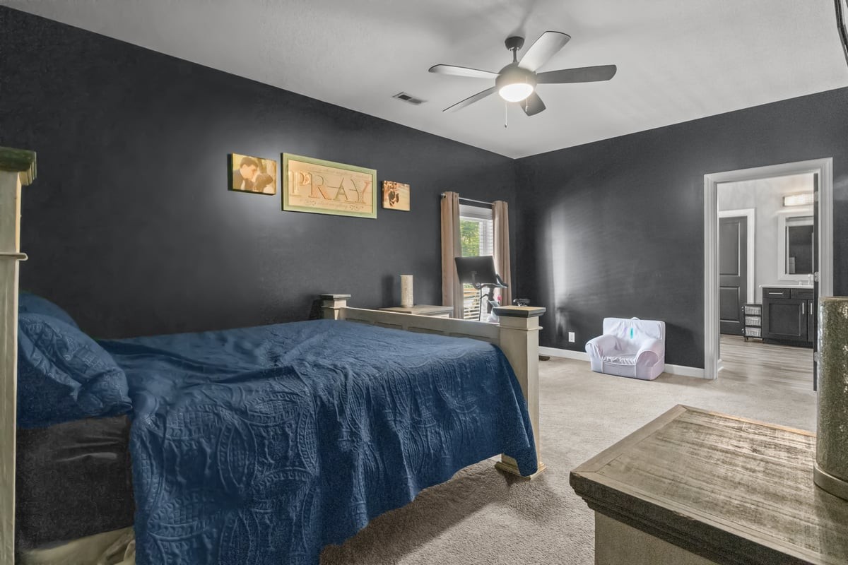 3950 Budds Creek Road Palmyra, TN 37142 - Photo 21 of 54 a bedroom with a bed and a chandelier