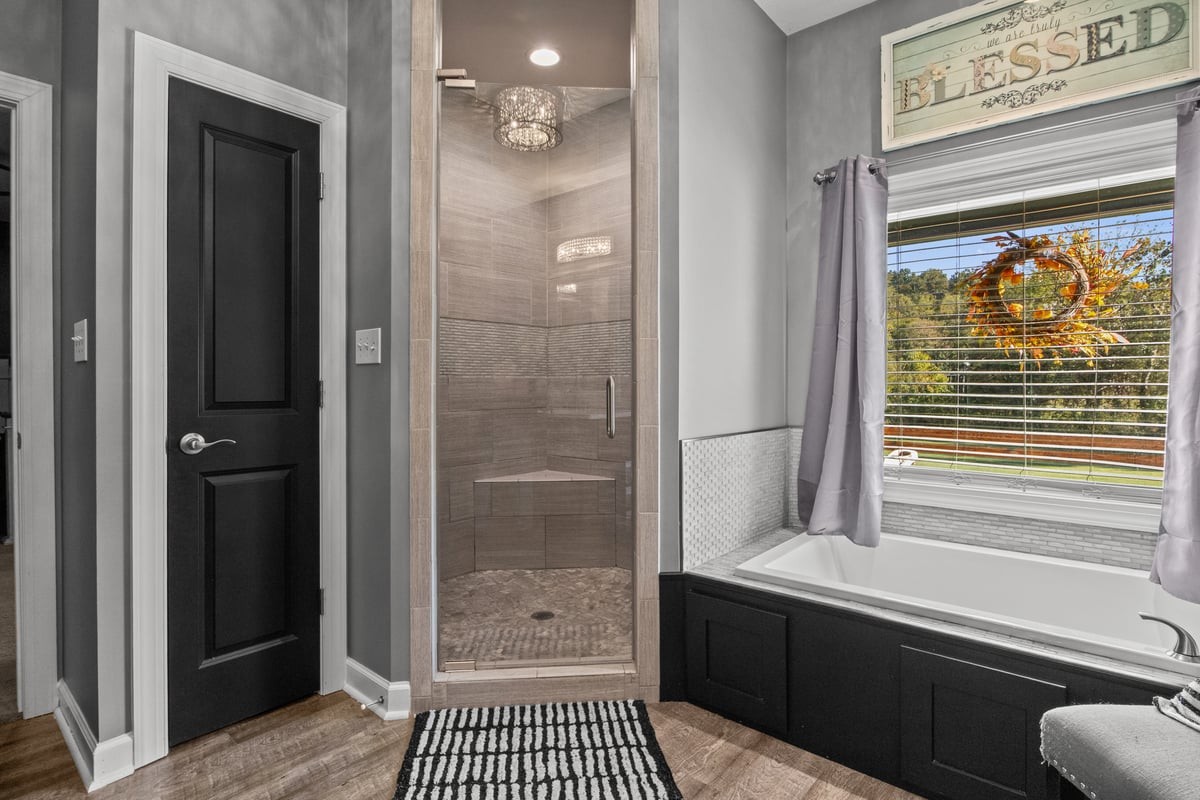 3950 Budds Creek Road Palmyra, TN 37142 - Photo 25 of 54 a bathroom with a bathtub and a shower