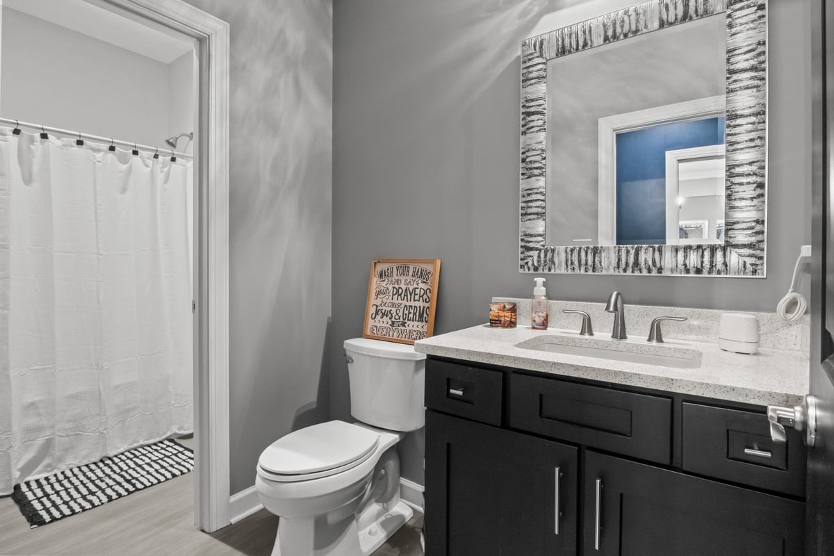 3950 Budds Creek Road Palmyra, TN 37142 - Photo 29 of 54 a bathroom with a toilet sink and mirror