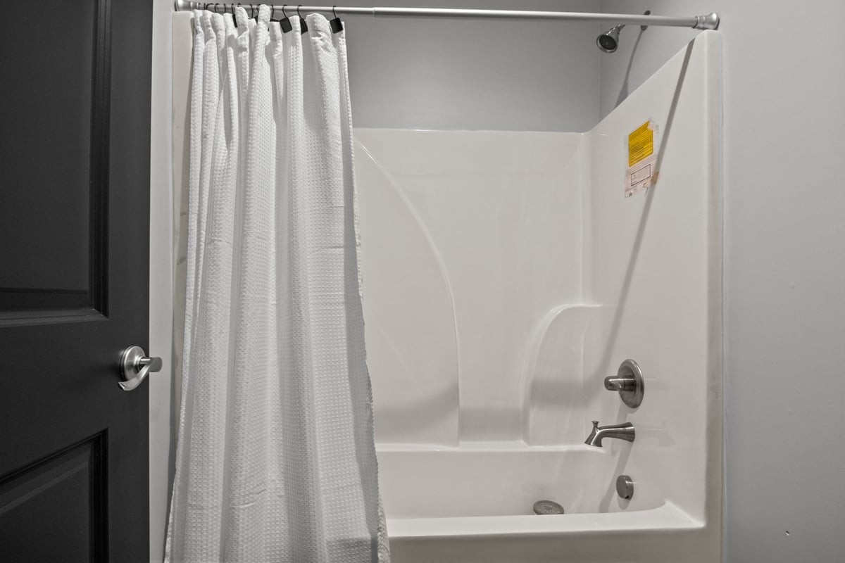 3950 Budds Creek Road Palmyra, TN 37142 - Photo 30 of 54 a bathroom with a bathtub and a shower